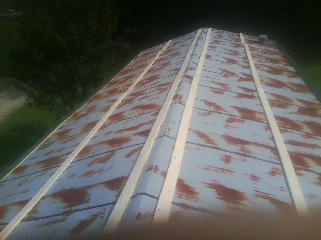 Rusted metal roof panels with new wood purlins before replacement — Storm Damage Roof Repair in South Bethlehem by Roofing Brothers
