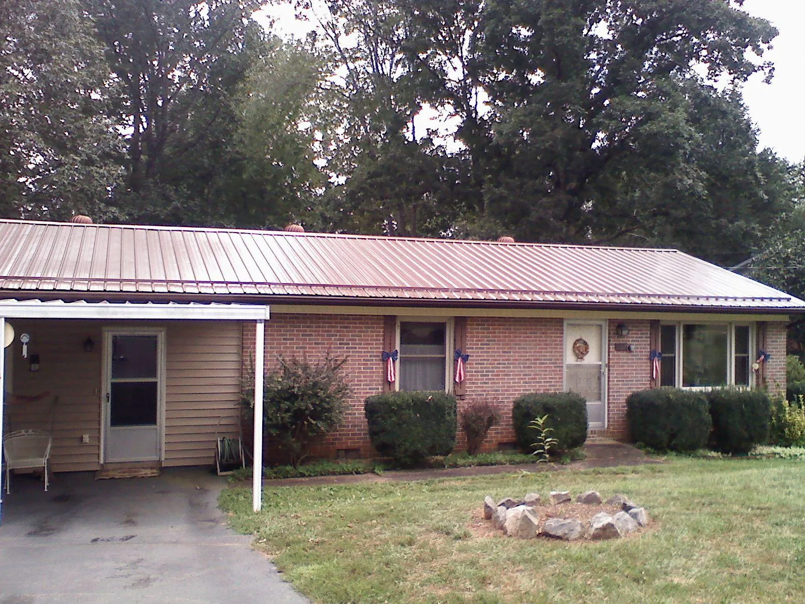 Bronze metal roof and carport on a brick ranch home — Roof Repair work by our crew in South Bethlehem