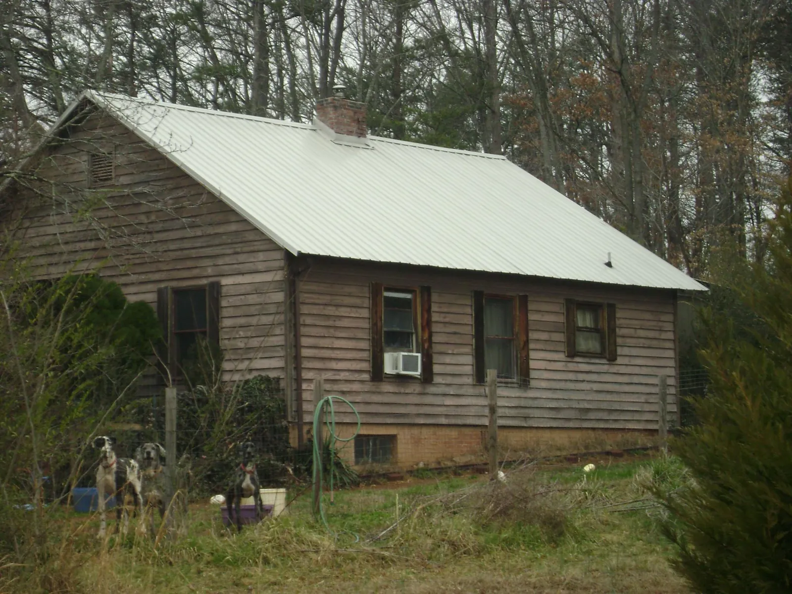 White metal roof on an old wood sided farmhouse, from a Metal Roof Installation job in South Bethlehem